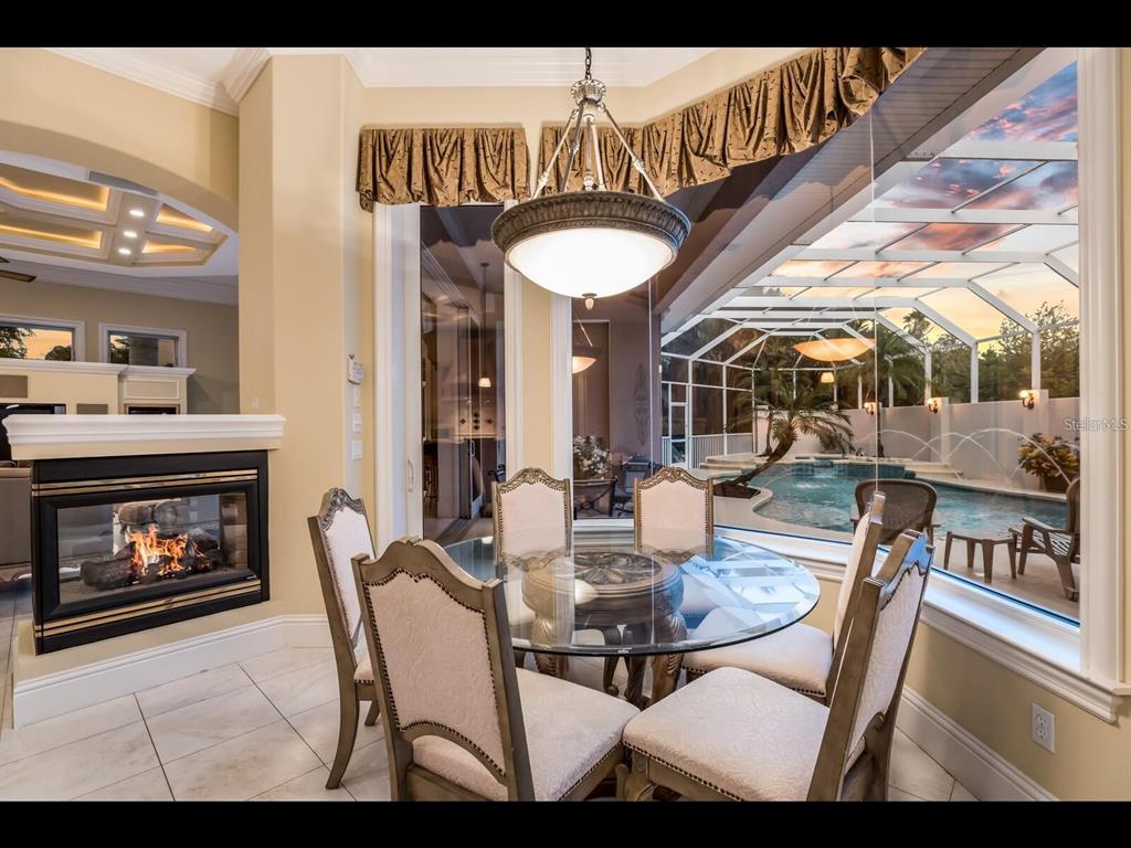 1102 Horizon View Drive Sarasota, FL 34242 - Photo 19 of 56 a dining room with furniture and a fireplace