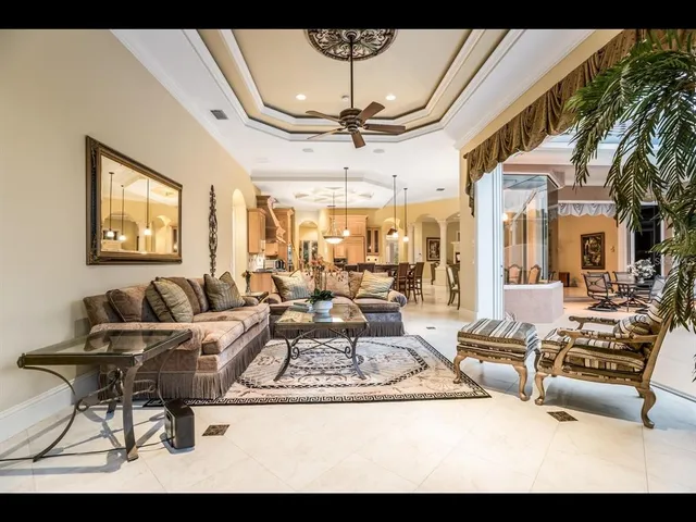 a living room with furniture and a chandelier