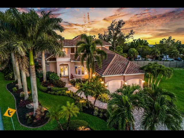 a view of a house with a yard and potted plants