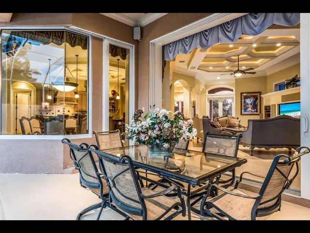 a dining room with furniture and a large window