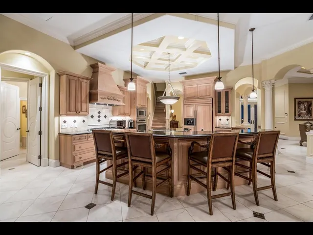 a dining area with a table chairs and a view of kitchen