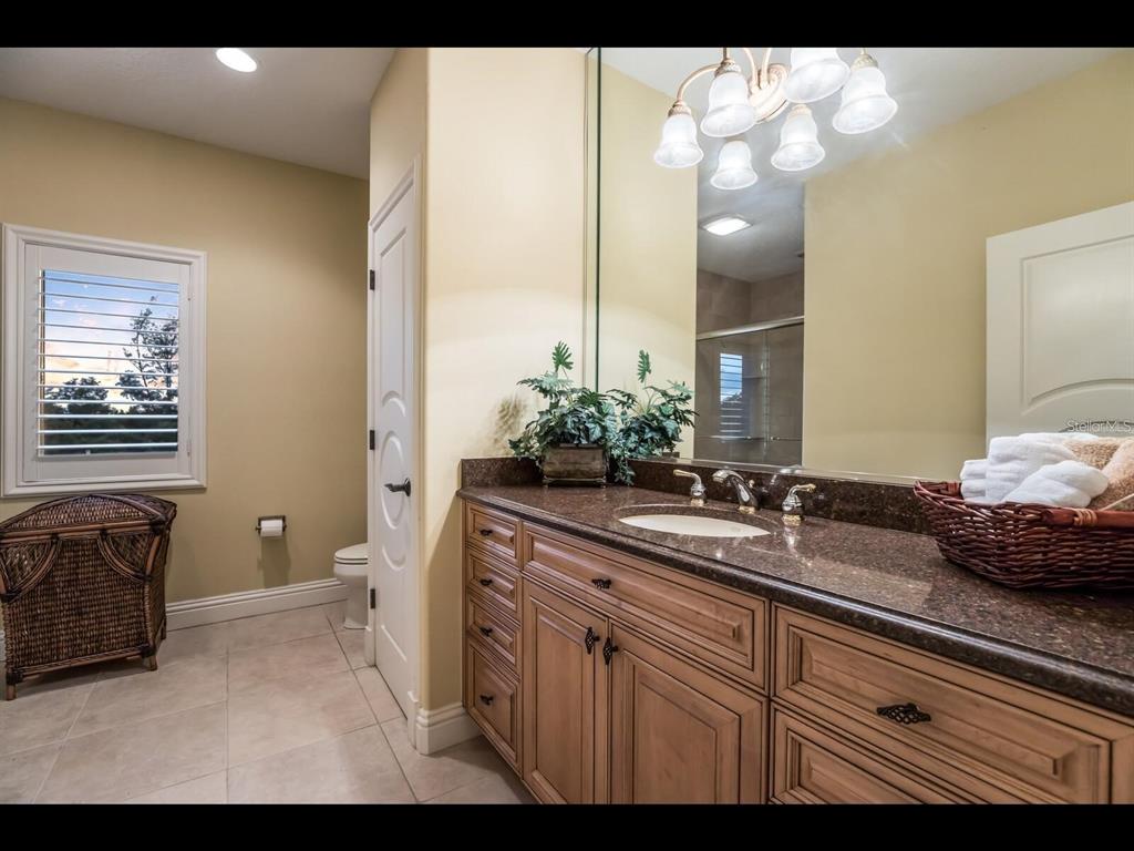 1102 Horizon View Drive Sarasota, FL 34242 - Photo 32 of 56 a bathroom with a sink and a mirror