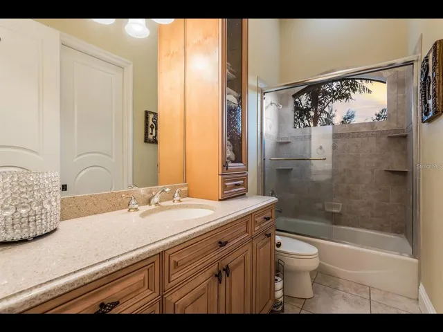 a bedroom with a bed and dresser with mirror