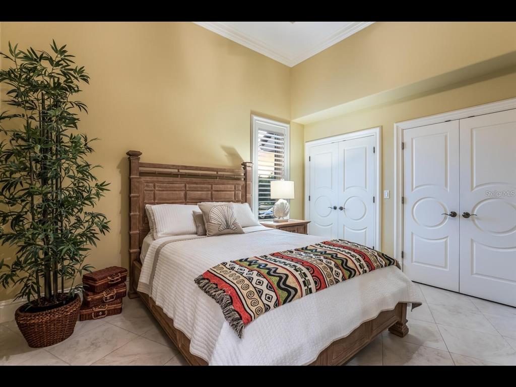 1102 Horizon View Drive Sarasota, FL 34242 - Photo 36 of 56 a bedroom with a bed and a potted plant