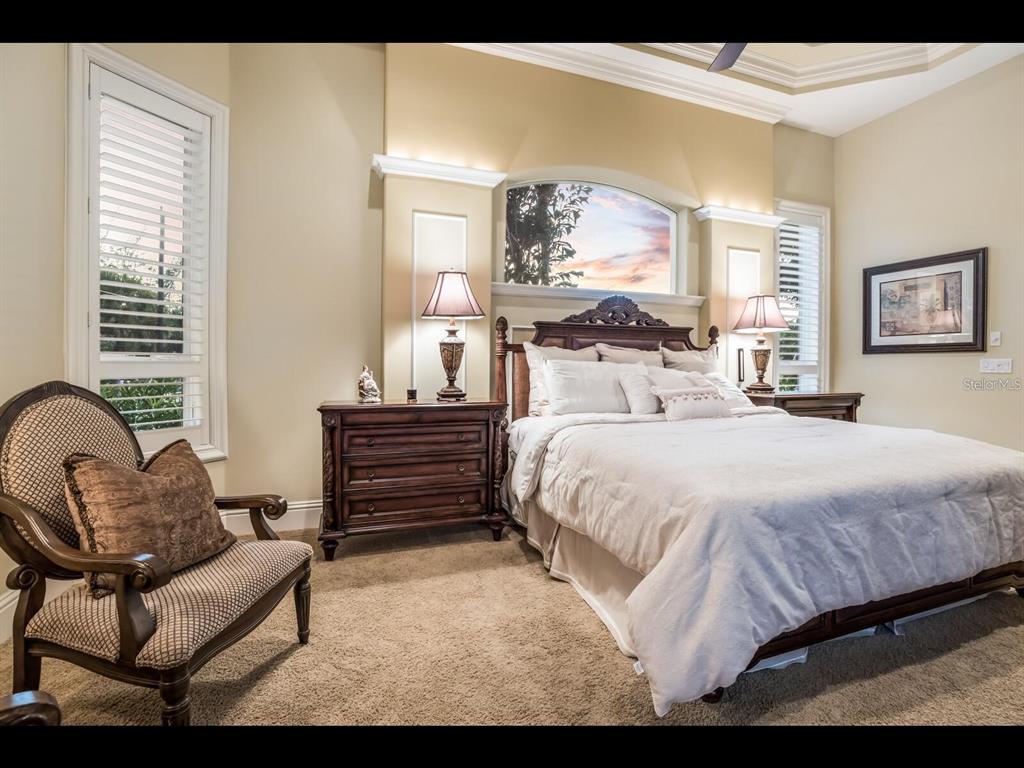 1102 Horizon View Drive Sarasota, FL 34242 - Photo 39 of 56 a bedroom with a bed and wooden floor