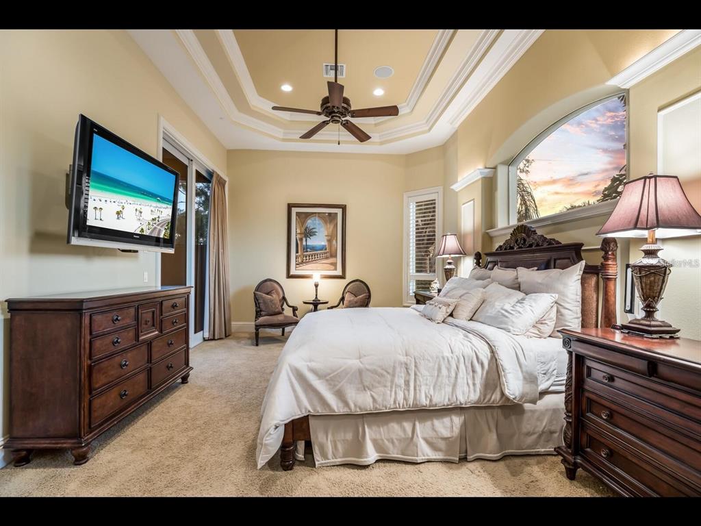 1102 Horizon View Drive Sarasota, FL 34242 - Photo 42 of 56 a bedroom with a bed and dresser with chair