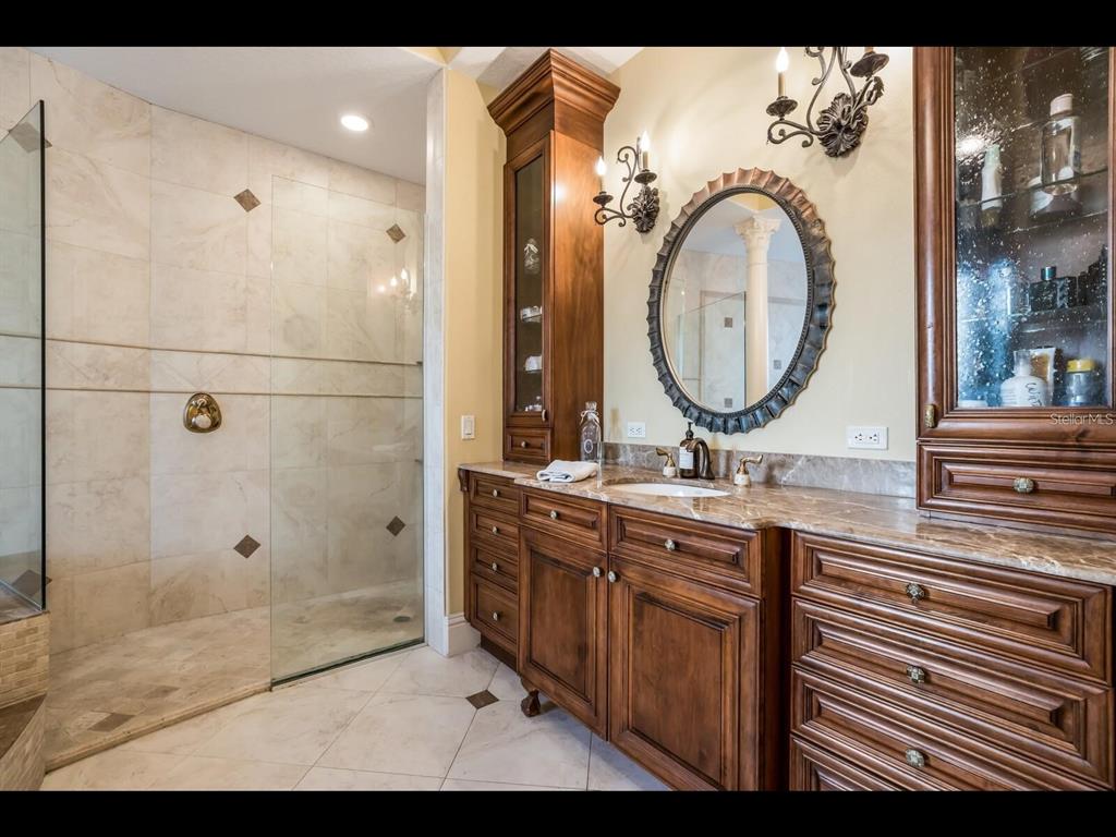 1102 Horizon View Drive Sarasota, FL 34242 - Photo 43 of 56 a bathroom with a double vanity sink mirror and shower