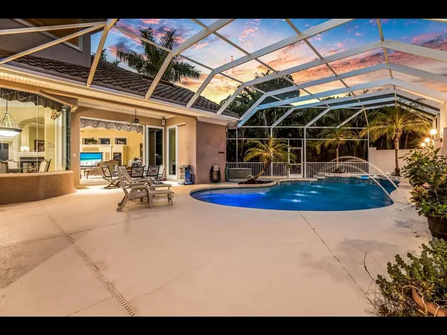 a view of a swimming pool with a patio and yard