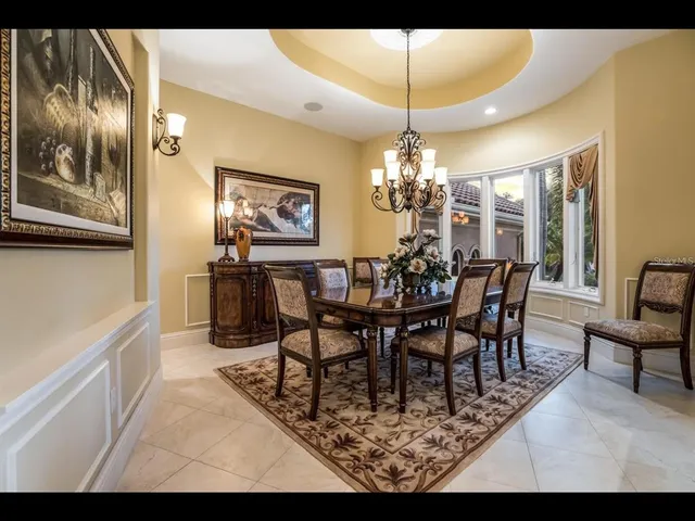 a view of a dining room with furniture and chandelier