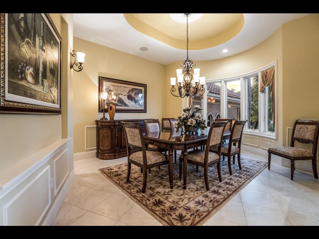 1102 Horizon View Drive Sarasota, FL 34242 - Photo 7 of 56 a view of a dining room with furniture and chandelier
