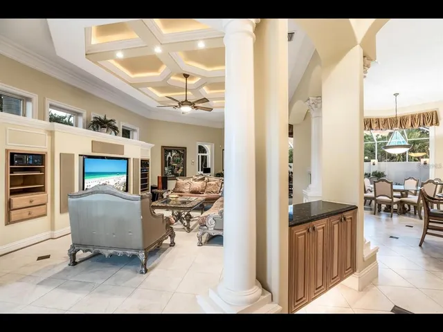 a living room with furniture a dining table and chairs with wooden floor