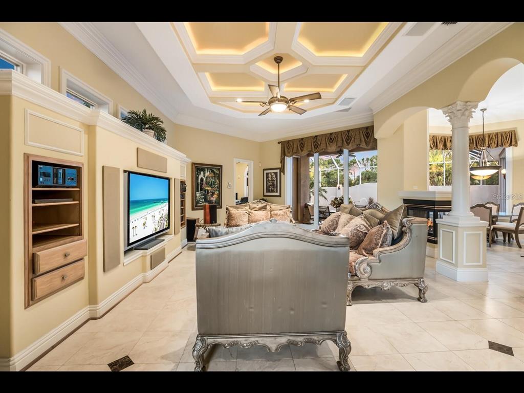 1102 Horizon View Drive Sarasota, FL 34242 - Photo 10 of 56 a living room with furniture a flat screen tv and a floor to ceiling window