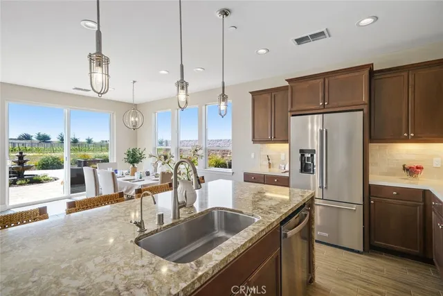 a kitchen with a table chairs and wooden floor