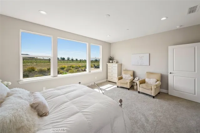 a bed room with a bed and a large window