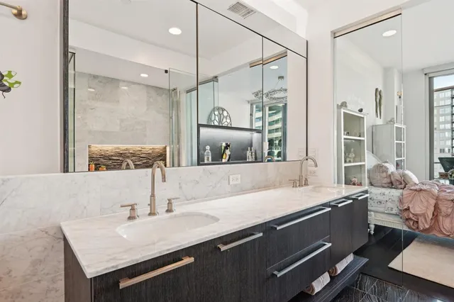 a bathroom with a sink double vanity and a shower