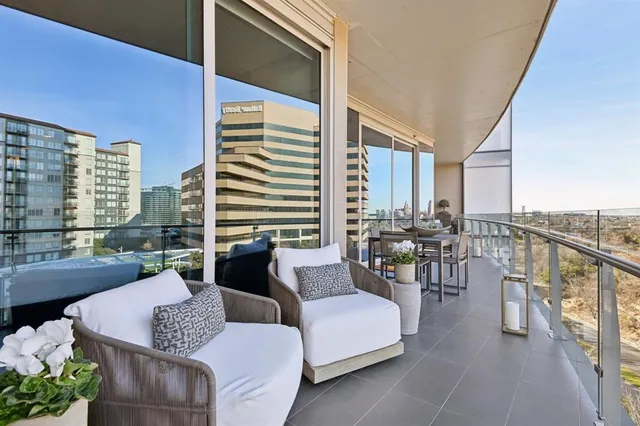a very nice looking living room with furniture and floor to ceiling windows