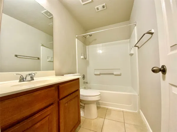 a bath room with a sink a mirror and a bath tub