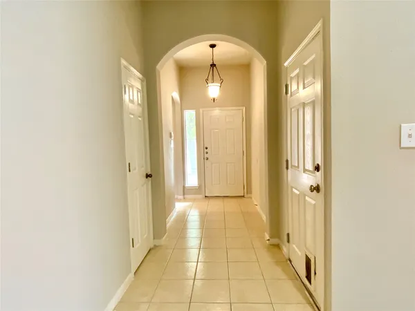 a view of a hallway with wooden shelves