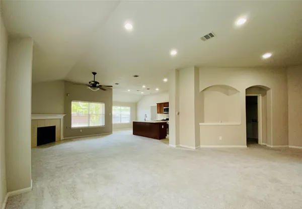 a view of an empty room and a fireplace