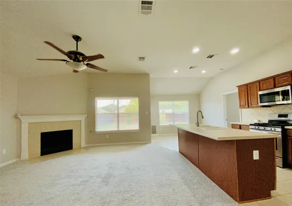 a bathroom with a granite countertop sink a toilet and shower