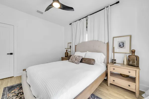 a large bedroom with a bed and a chandelier