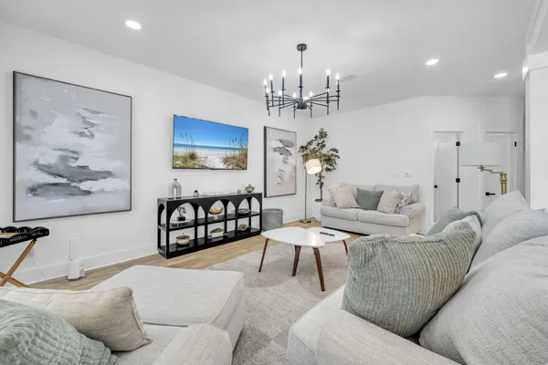 a living room with furniture and a chandelier