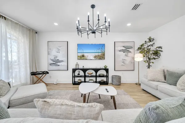 a living room with furniture and a chandelier