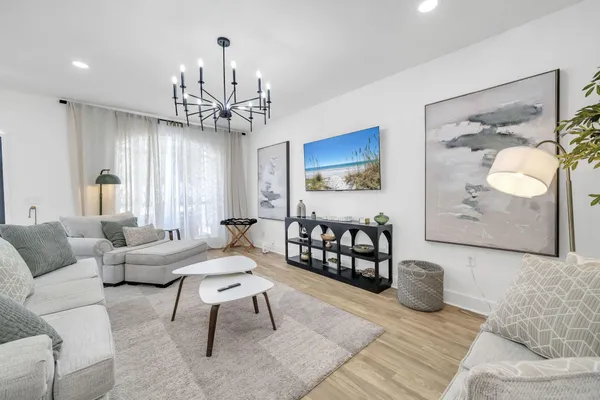 a living room with furniture and wooden floor
