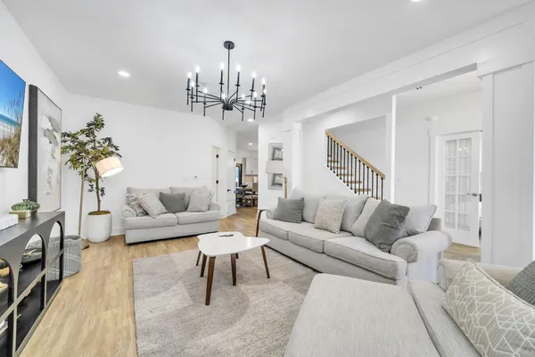 a bedroom with a bed and a chandelier