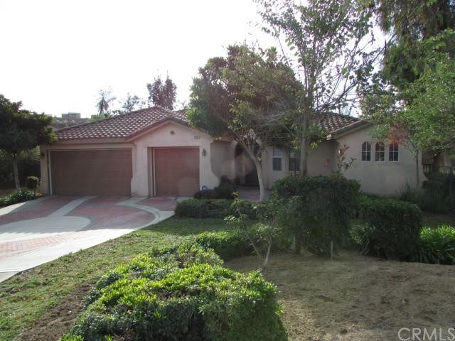 12307 Tuliptree Circle Riverside, CA 92503 - Photo 1 of 1 a front view of a house with garden