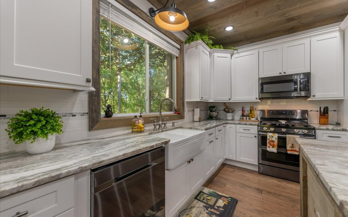 129 Madola Road Epworth, GA 30513 - Photo 21 of 46 a kitchen with a sink stainless steel appliances and cabinets