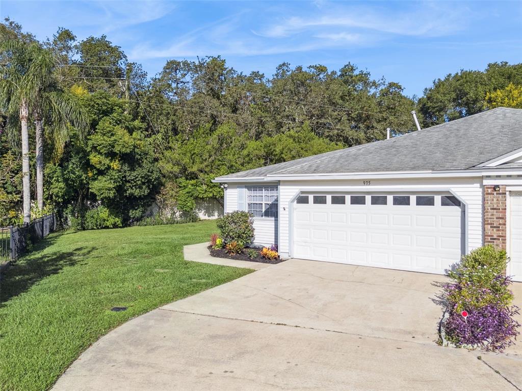 a front view of a house with a yard and trees
