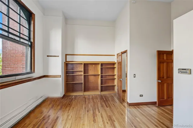 a view of a room with wooden floor and window