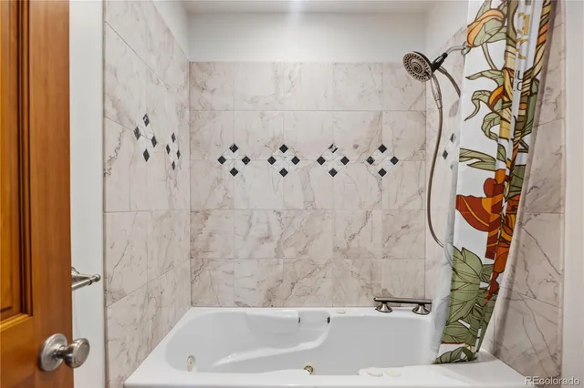 a bathroom with a bathtub and shower