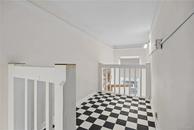 a bedroom with a black and white checkered floor
