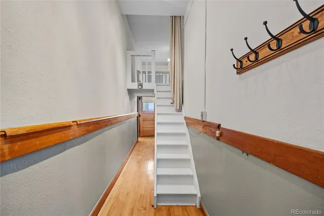 a view of a room with wooden floor and stairs