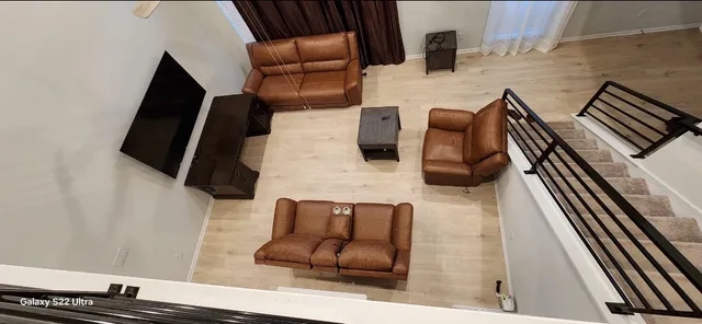 a view of living room with furniture and wooden floor