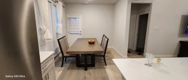 a view of a dining room with furniture and wooden floor