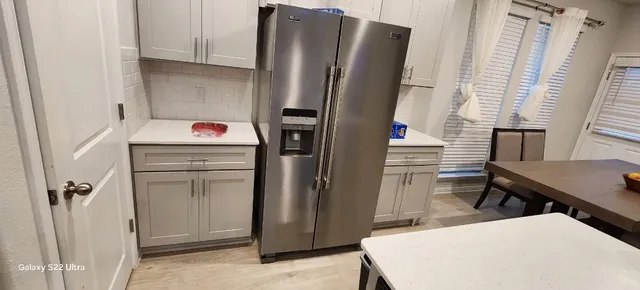 a room with refrigerator and window