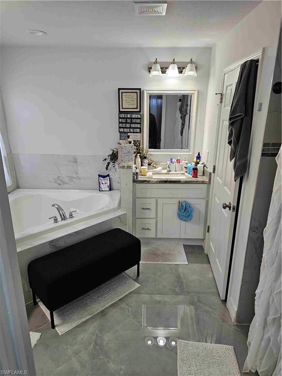 3507 2nd Street Southwest Lehigh Acres, FL 33976 - Photo 12 of 27 Full bathroom featuring a bath and vanity