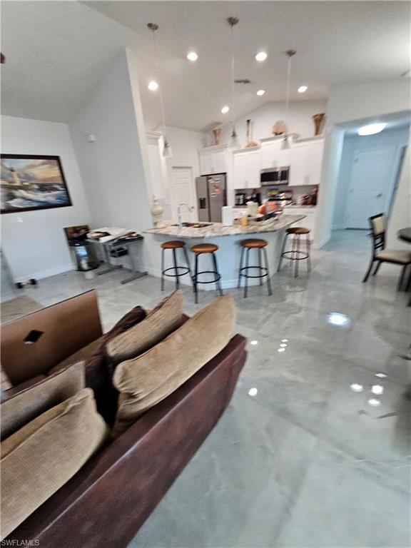 3507 2nd Street Southwest Lehigh Acres, FL 33976 - Photo 15 of 27 Living area with vaulted ceiling and recessed lighting