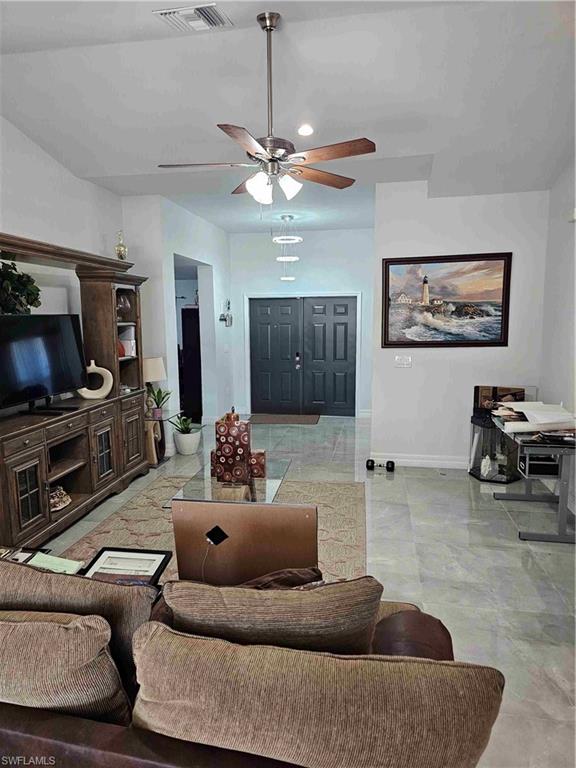 3507 2nd Street Southwest Lehigh Acres, FL 33976 - Photo 19 of 27 Living room featuring ceiling fan and light marble finish floors