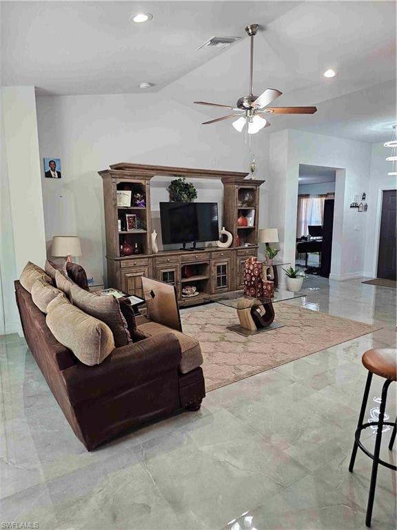 3507 2nd Street Southwest Lehigh Acres, FL 33976 - Photo 20 of 27 Living room with a ceiling fan, recessed lighting, and light marble finish floors
