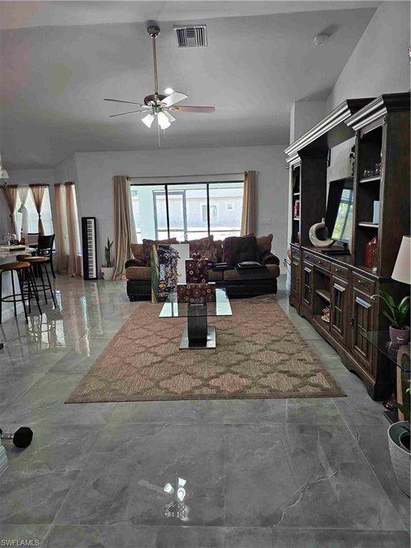 3507 2nd Street Southwest Lehigh Acres, FL 33976 - Photo 22 of 27 Living area featuring ceiling fan and light marble finish floors