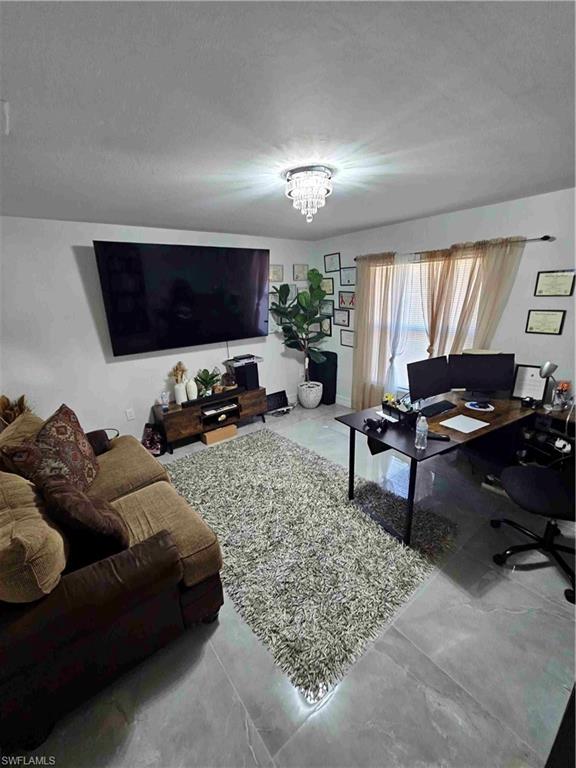 3507 2nd Street Southwest Lehigh Acres, FL 33976 - Photo 26 of 27 Living area featuring a desk