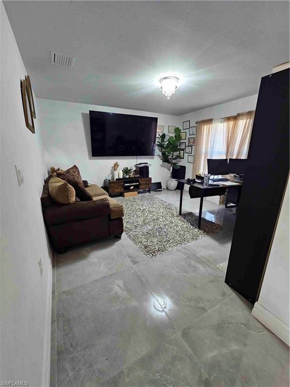 3507 2nd Street Southwest Lehigh Acres, FL 33976 - Photo 27 of 27 Living area featuring baseboards