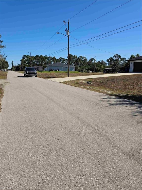 3507 2nd Street Southwest Lehigh Acres, FL 33976 - Photo 5 of 27 View of asphalt road featuring street lights