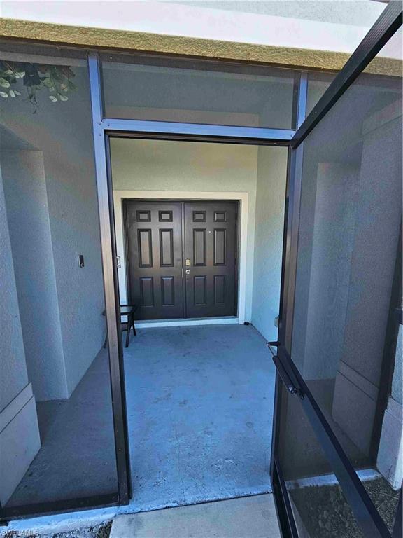 3507 2nd Street Southwest Lehigh Acres, FL 33976 - Photo 10 of 27 View of exterior entry featuring stucco siding