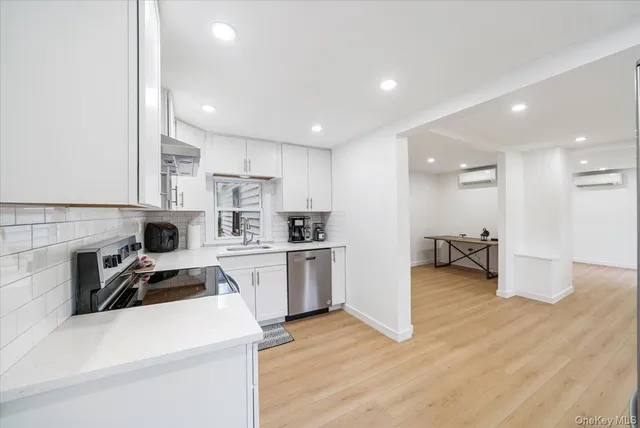 a kitchen view with cabinets a sink and appliances