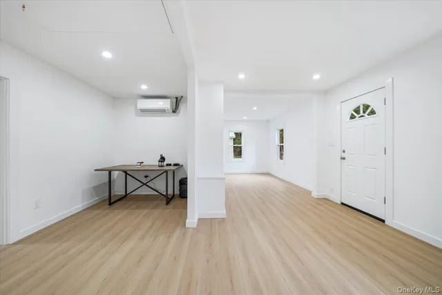 a view of a room with wooden floor and bench